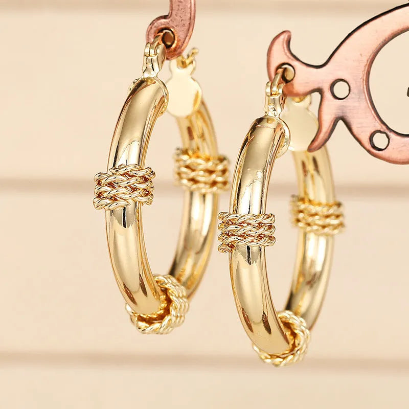 Geometric copper earrings for women with ring and line elements in golden colour