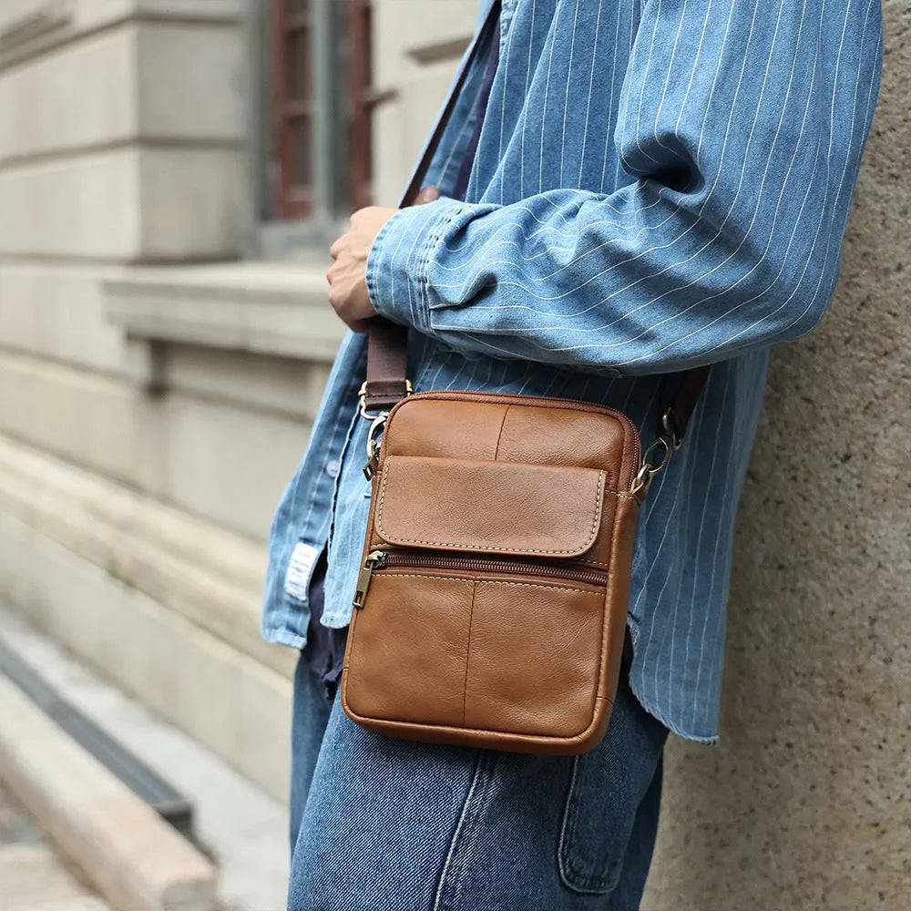 Men's brown genuine leather crossbody shoulder bag with visible stitching.
