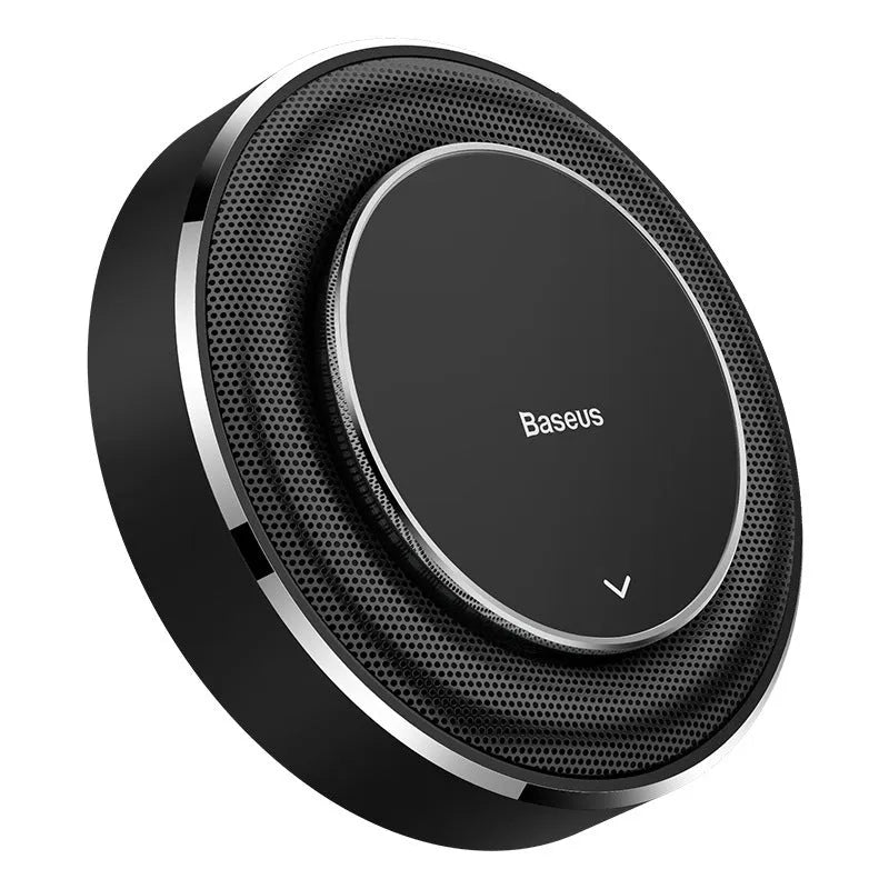 Black aluminium alloy round car fragrance seat with aromatherapy tablets on a car dashboard.