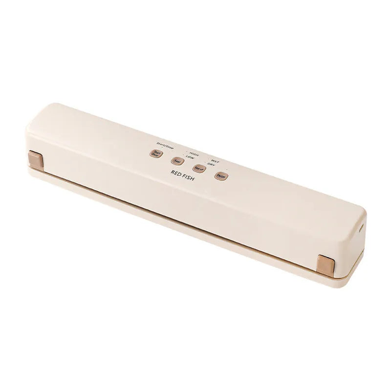 Off-white plastic vacuum sealing machine for home food packaging on a kitchen counter