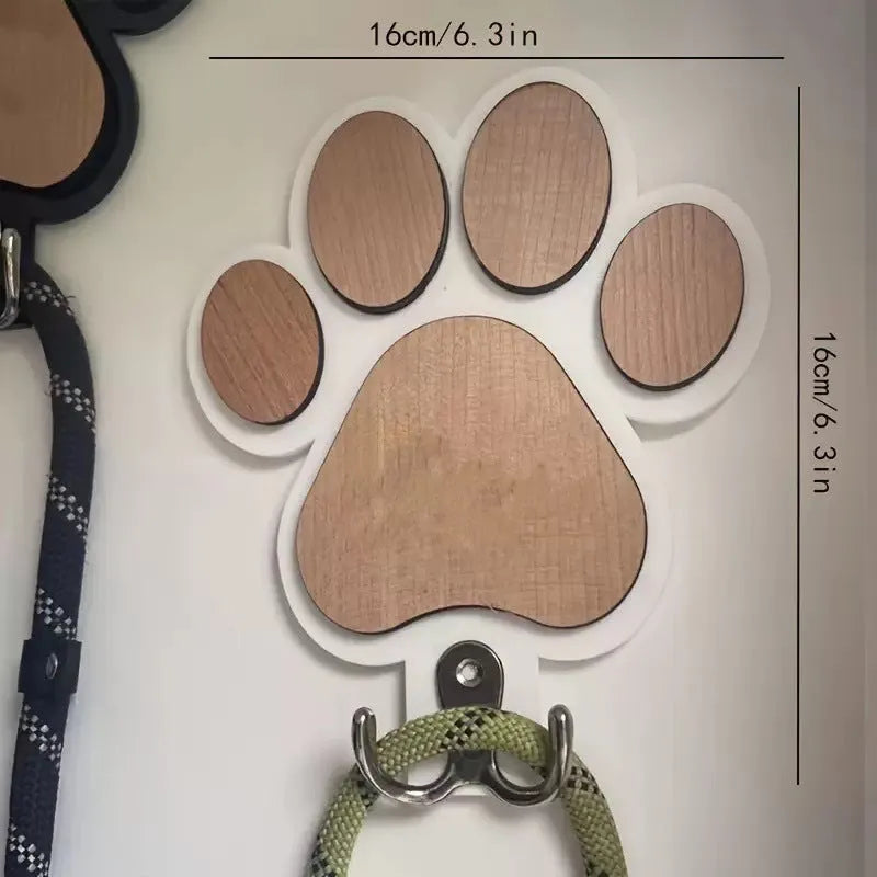 Wooden foot paw print wall hook in black finish, modern simplicity style, with a coat hanging from it