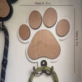 Wooden foot paw print wall hook in black finish, modern simplicity style, with a coat hanging from it