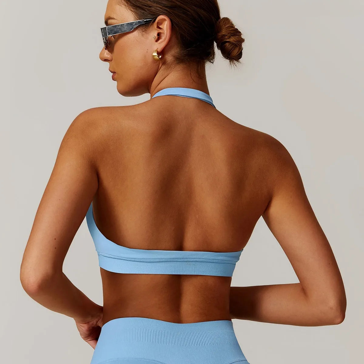 Women's halter sports bra in nylon with removable pads in black, red, purple, brown, or blue