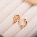 Rose gold plated copper leaf earrings with hollowed out design and heart-shaped detail