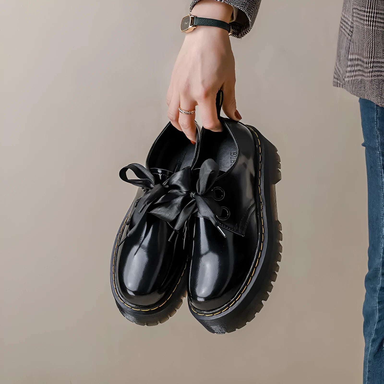 Women's black thick-soled leather shoes with cross strap design and lace-up closure