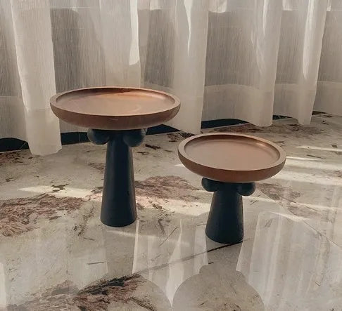 Nordic style wooden tray with four raised legs holding candles and aromatherapy bottles