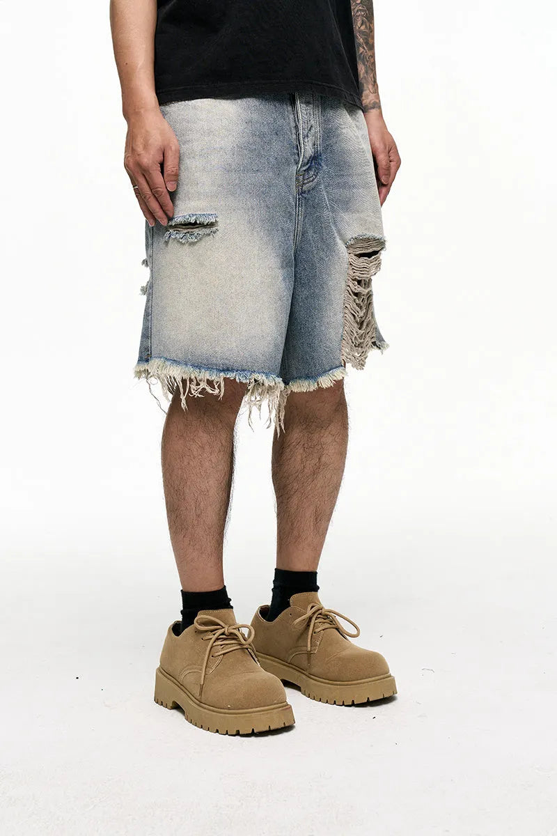 Light blue retro washed men's baggy denim shorts on a hanger showing wide leg fit.