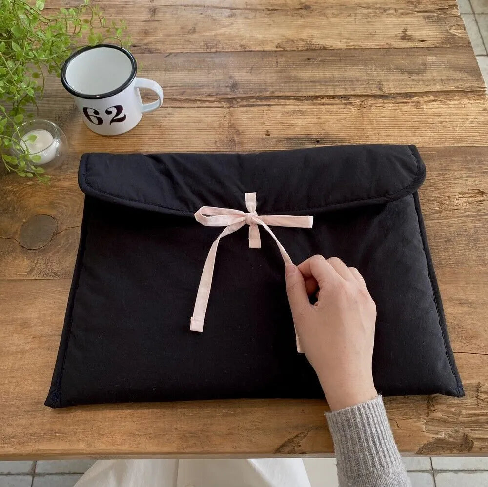 Women's black quilted computer bag with ballet bow and striped pattern