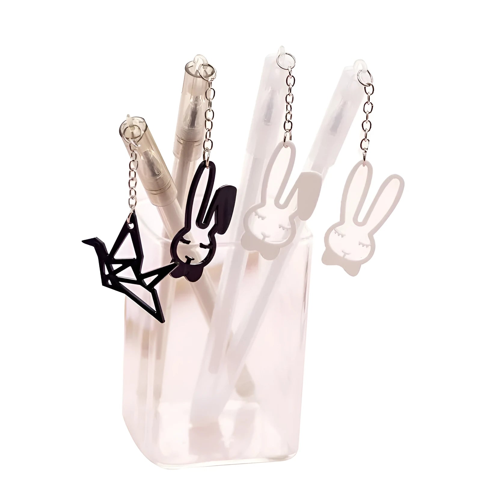 White gel pen with paper crane pendant and black gel pen with rabbit pendant on cap.