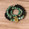 Green and black alloy beaded elastic bracelet laid flat showing alternating colour pattern