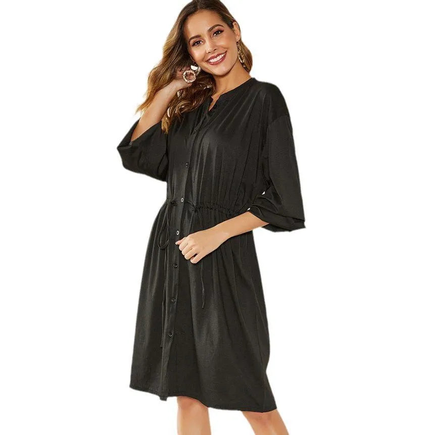 Black A-line dress with elastic waist, long sleeves with elastic cuffs and matching belt