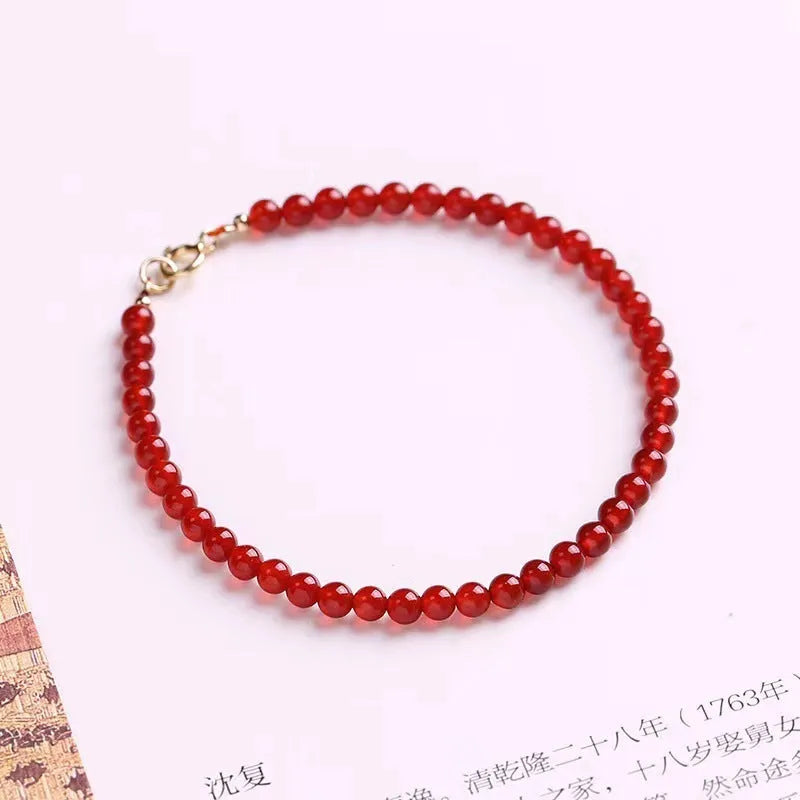 Ultra-thin red agate small bracelet for women, classic style, on a plain background.