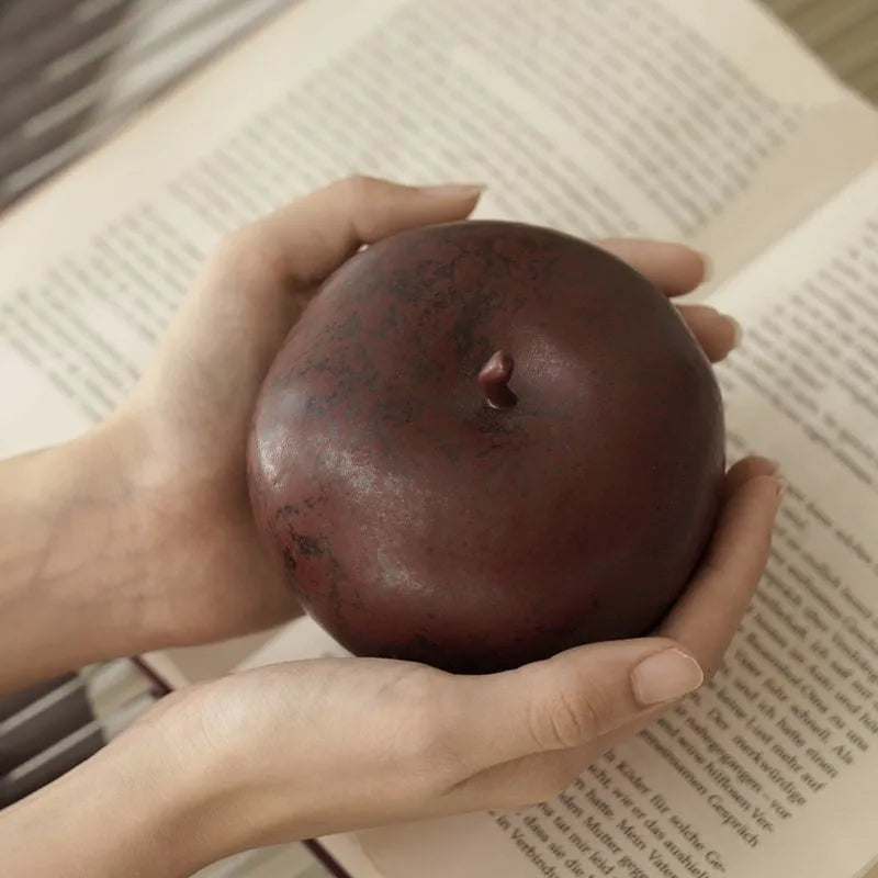 Retro Chinese style ceramic simulation apple ornament for desktop decoration on a wooden surface.