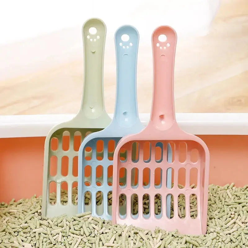 Blue plastic cat litter scoop on a white background showing its 20cm length.