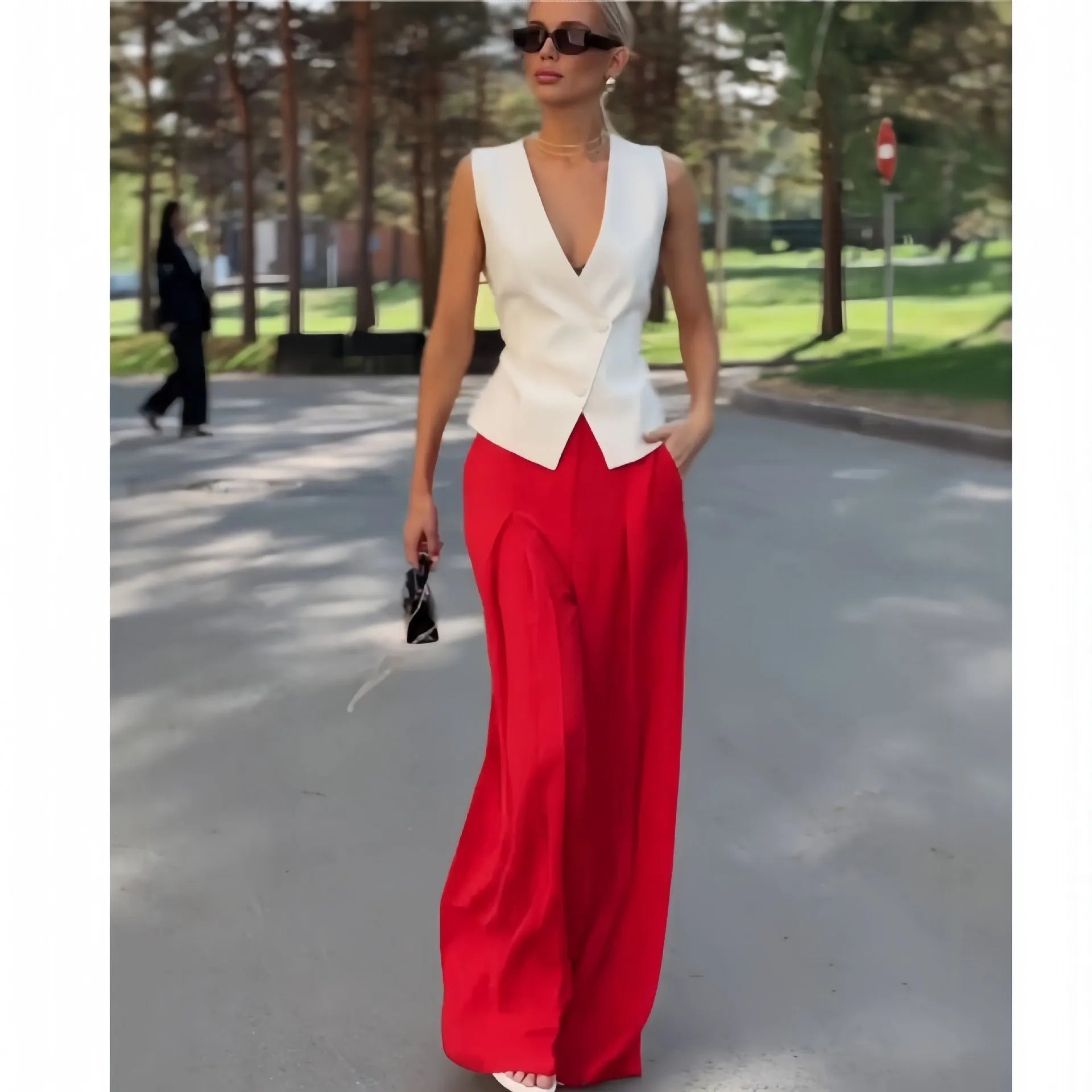 Women's beige deep V-neck sleeveless top and high waist wide leg pants two-piece set on model