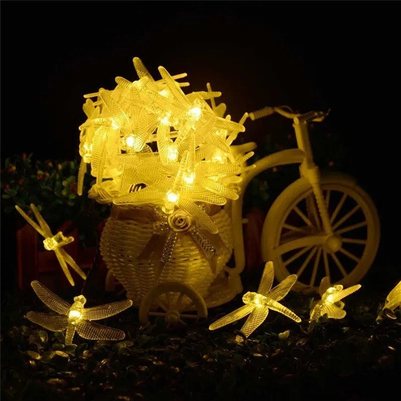 Outdoor solar LED string light with 30 warm white LEDs on 6-metre cable, solar panel with ground spike, and IP65 waterproof rating
