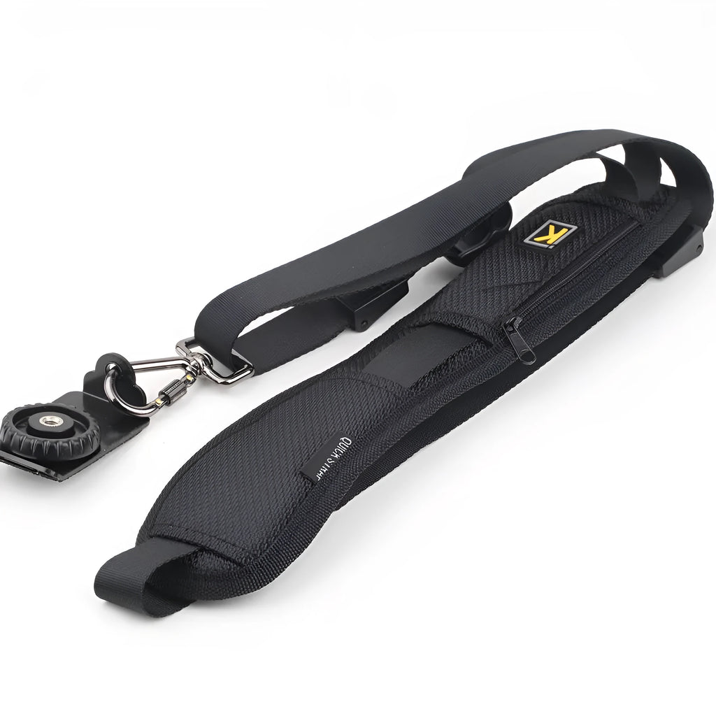 Black nylon DSLR sling strap with metal buckle and screw plate on table