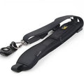 Black nylon DSLR sling strap with metal buckle and screw plate on table