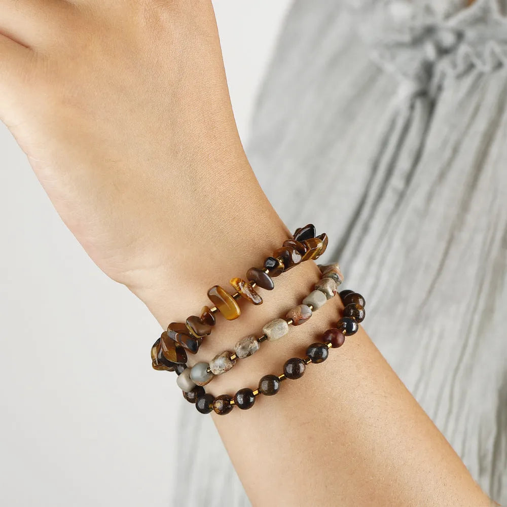 Tigereye Gravel Bronze Glow Ball Bracelet on brown background, handmade geometric texture