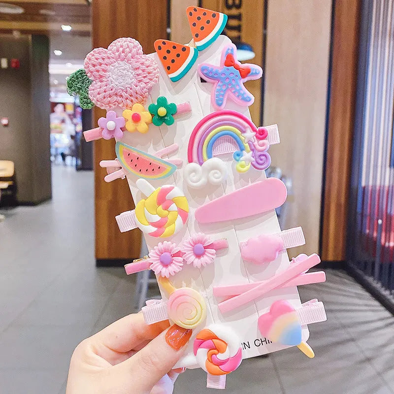 14-piece toddler hair accessories set on display including rainbow barrettes, fruit clips, and butterfly pins in bright colours
