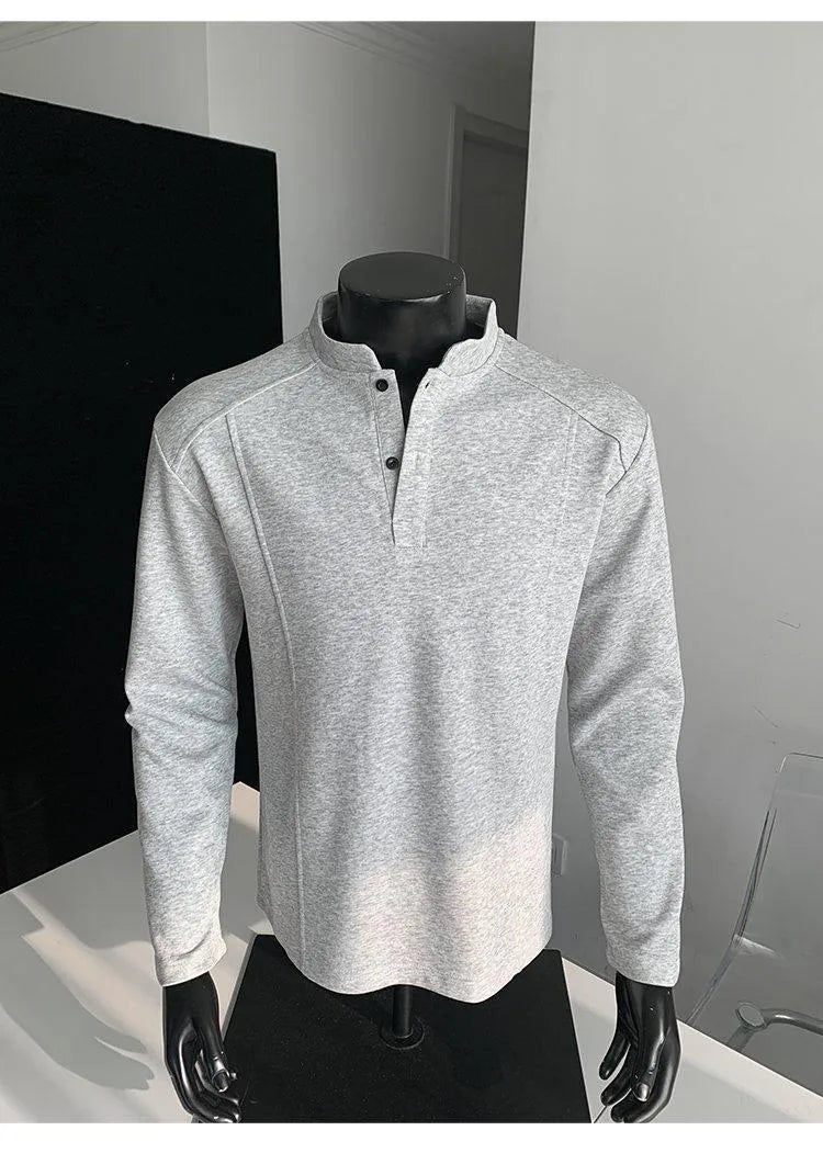 Man wearing a grey patchwork stand-up collar polo shirt with asymmetric shoulder detail
