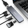 Silver aluminum Type C adapter with SD slot, HDMI port, and USB ports on a white background