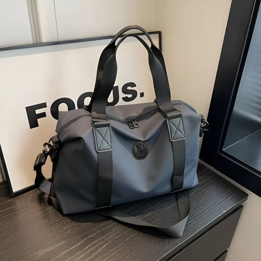 Waterproof Oxford cloth travel bag in black, blue, grey or red with 36-55 litre capacity