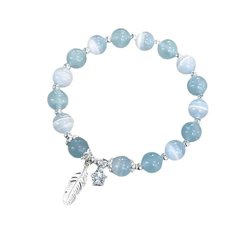 Small white girl crystal bracelet in feather XINGX blue moonlight with eight Awn star motif on wrist