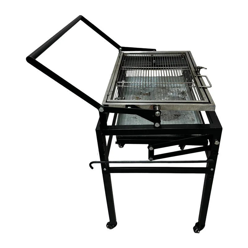 Large foldable Flip BBQ Stove charcoal barbecue grill set up in a garden.