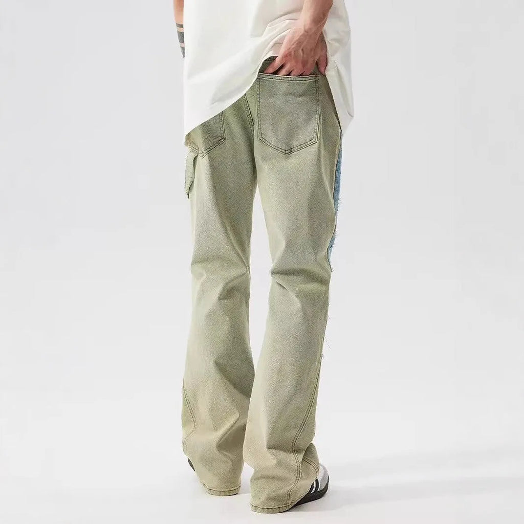 Retro dual-colour yellow and blue patchwork jeans with splash-ink damaged design, mid-waist cut