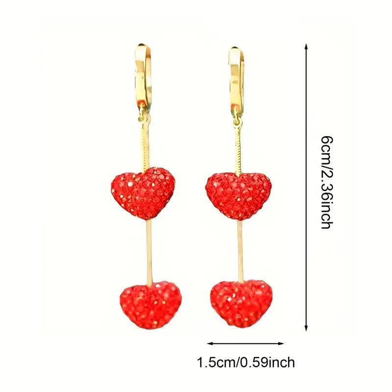Red heart-shaped long earrings for women made of alloy with an electroplated finish, shown against a neutral background.