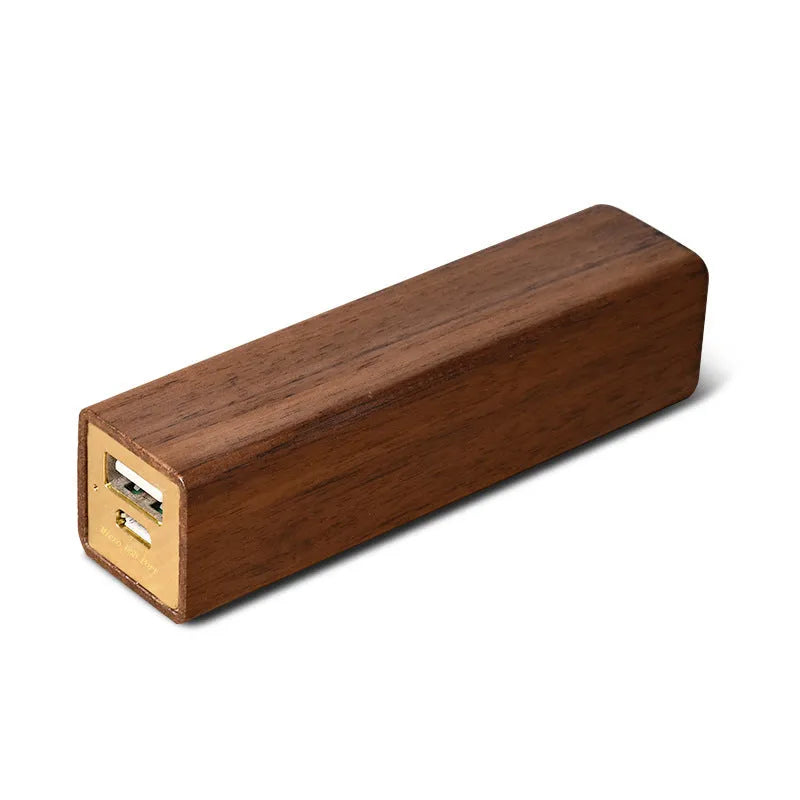 Portable power bank with brown walnut wood shell and USB port on a light background