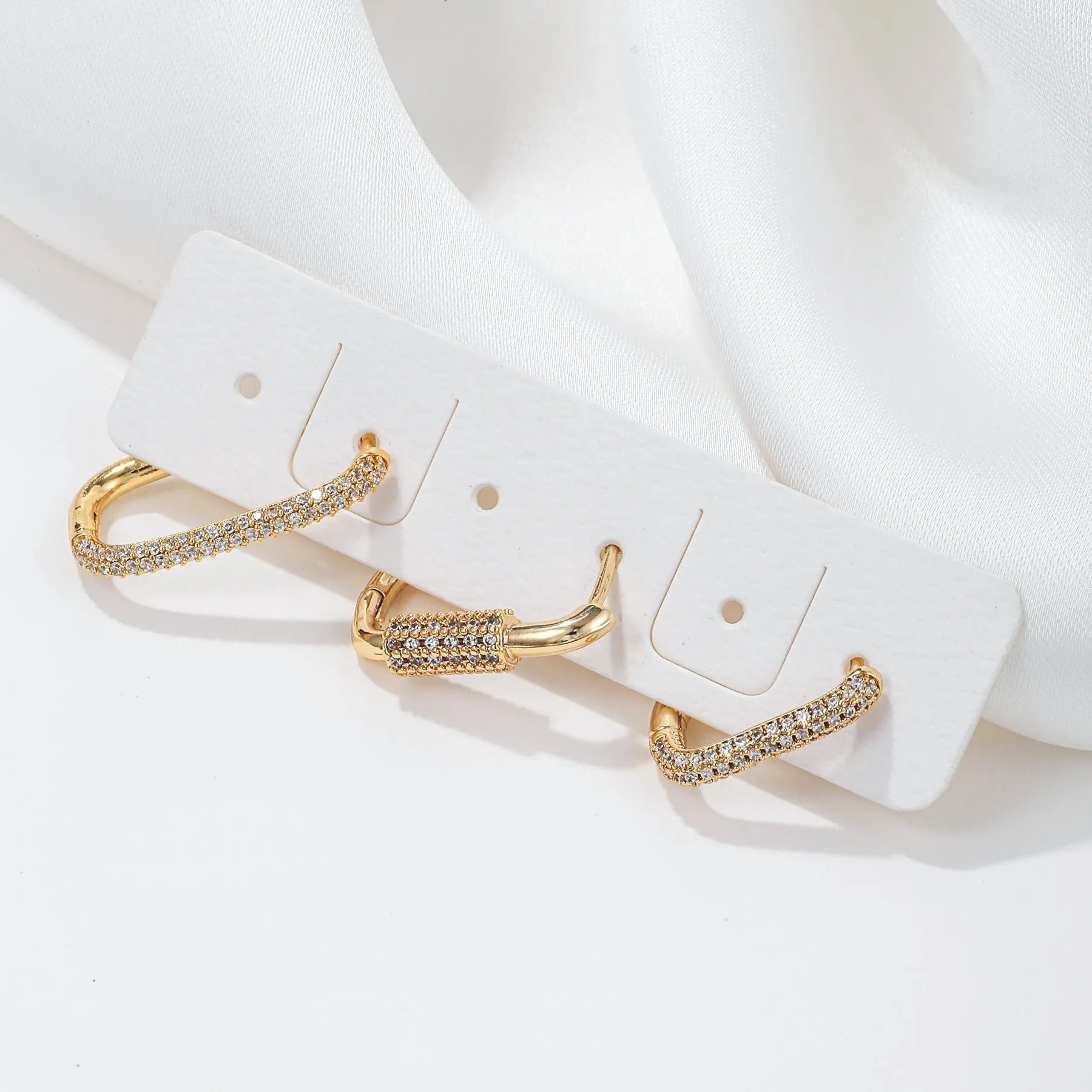 Three geometric ear clips with square design and micro inlaid zircon detailing in gold or white colour options