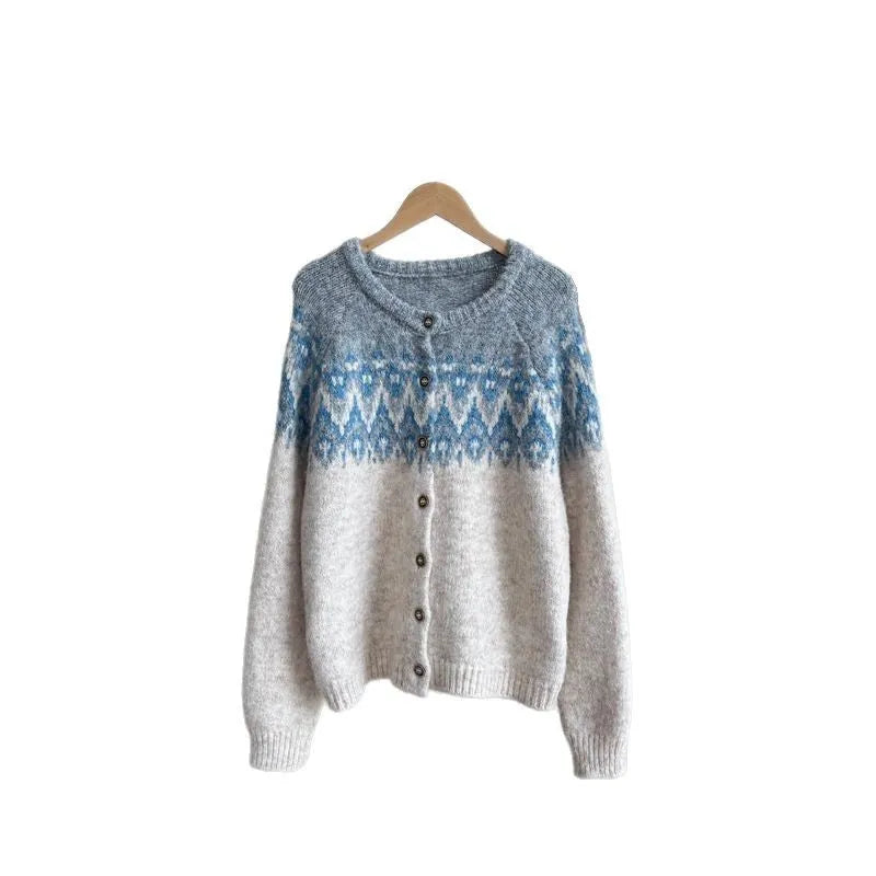 Women's beige jacquard knit sweater coat with loose fit and long sleeves on a hanger.