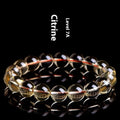 Natural citrine scattered bead bracelet in 7A or 6A grade on a wrist, showing five size options.