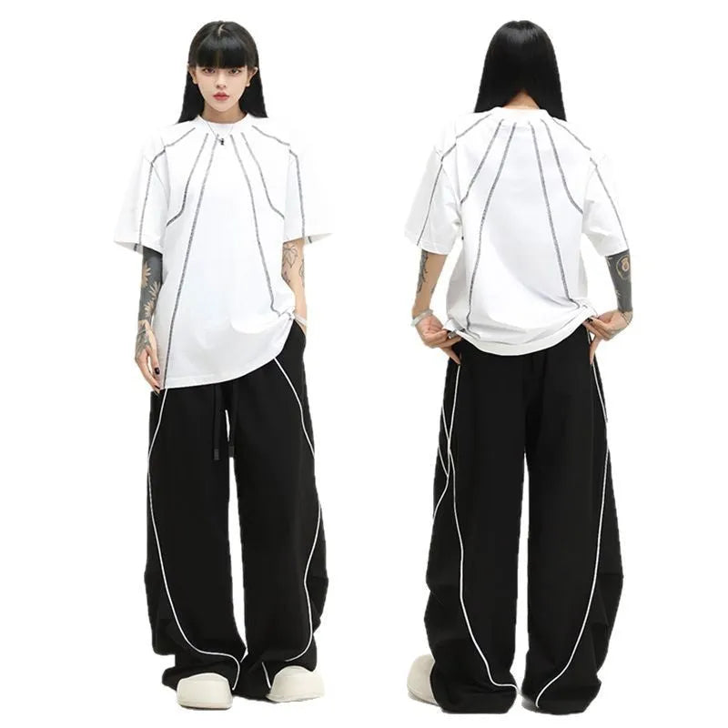 Black pleated wide-leg sports trousers with vertical stripe pattern and mid waist