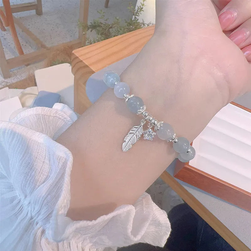 Small white girl crystal bracelet in feather XINGX blue moonlight with eight Awn star motif on wrist