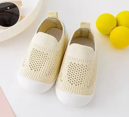 Baby soft sole non-slip walking shoes in cream yellow with fly woven cotton upper and natural rubber sole