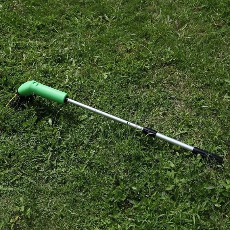Cordless lawn trimmer with lightweight extension pole and protective debris shield on grass