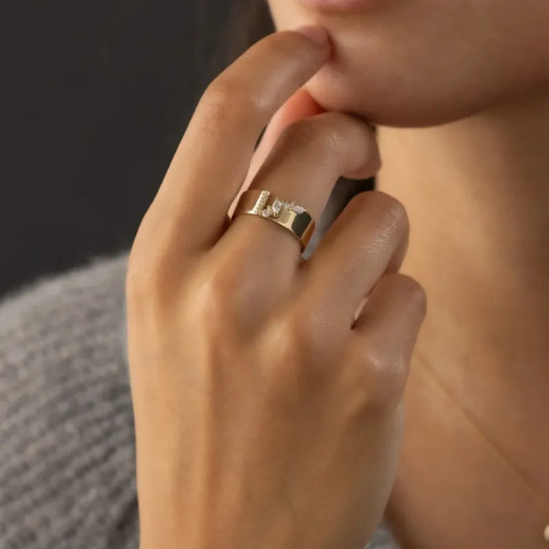 Gold electroplated women's ring with a shining zircon stone on a copper band.