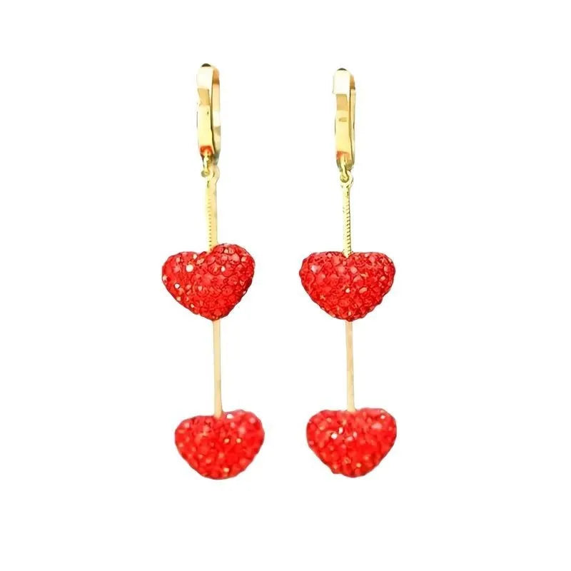 Red heart-shaped long earrings for women made of alloy with an electroplated finish, shown against a neutral background.