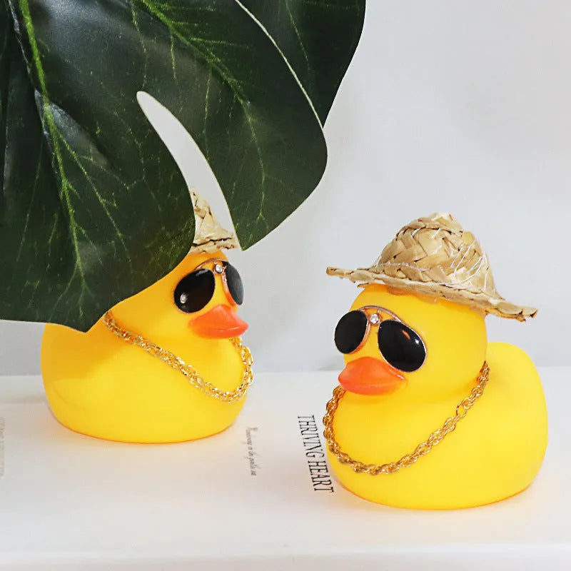 Yellow cartoon duck wearing a straw hat car dashboard ornament with adhesive and sunglasses accessory.