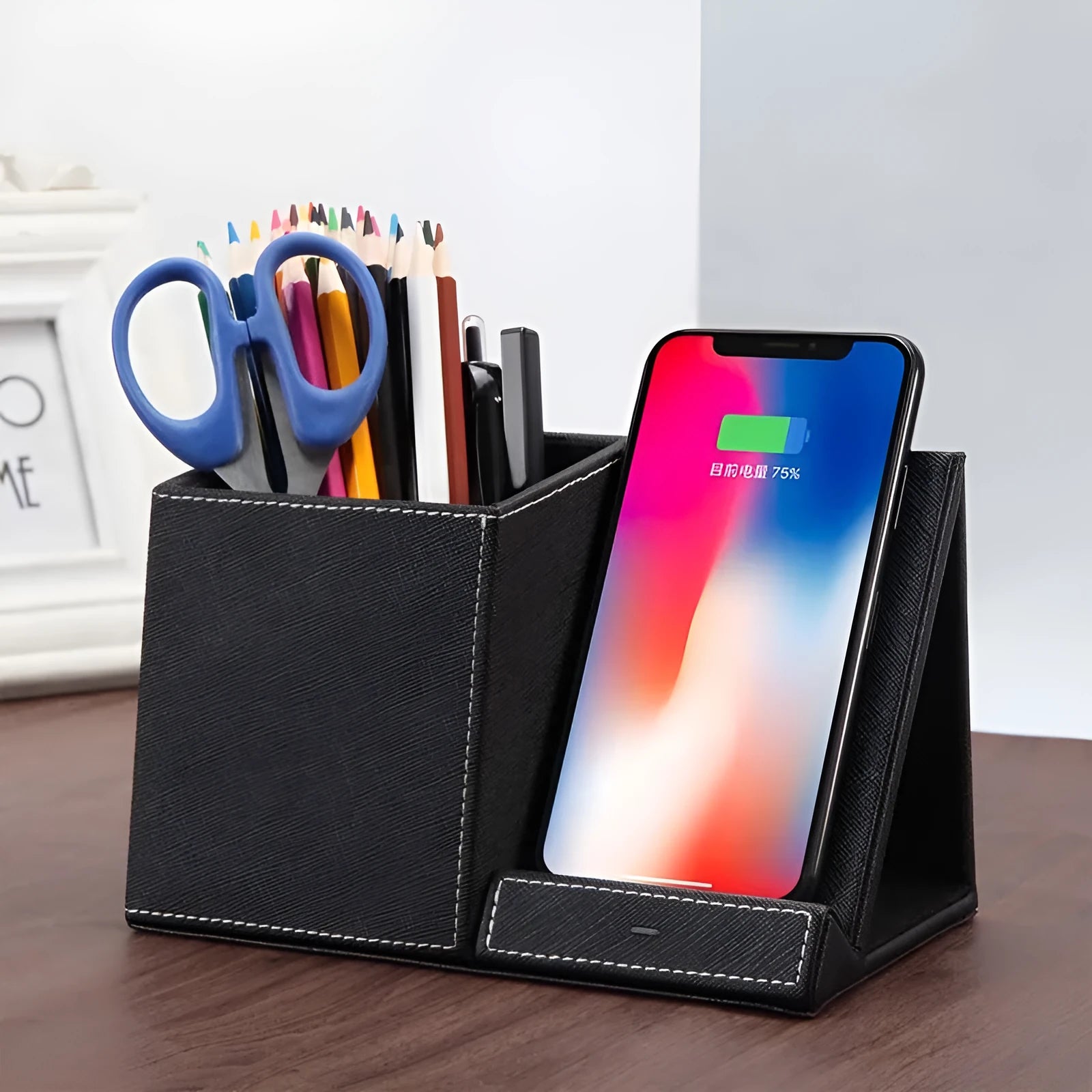 Leather pen holder wireless charger on desk with phone charging and pens organised