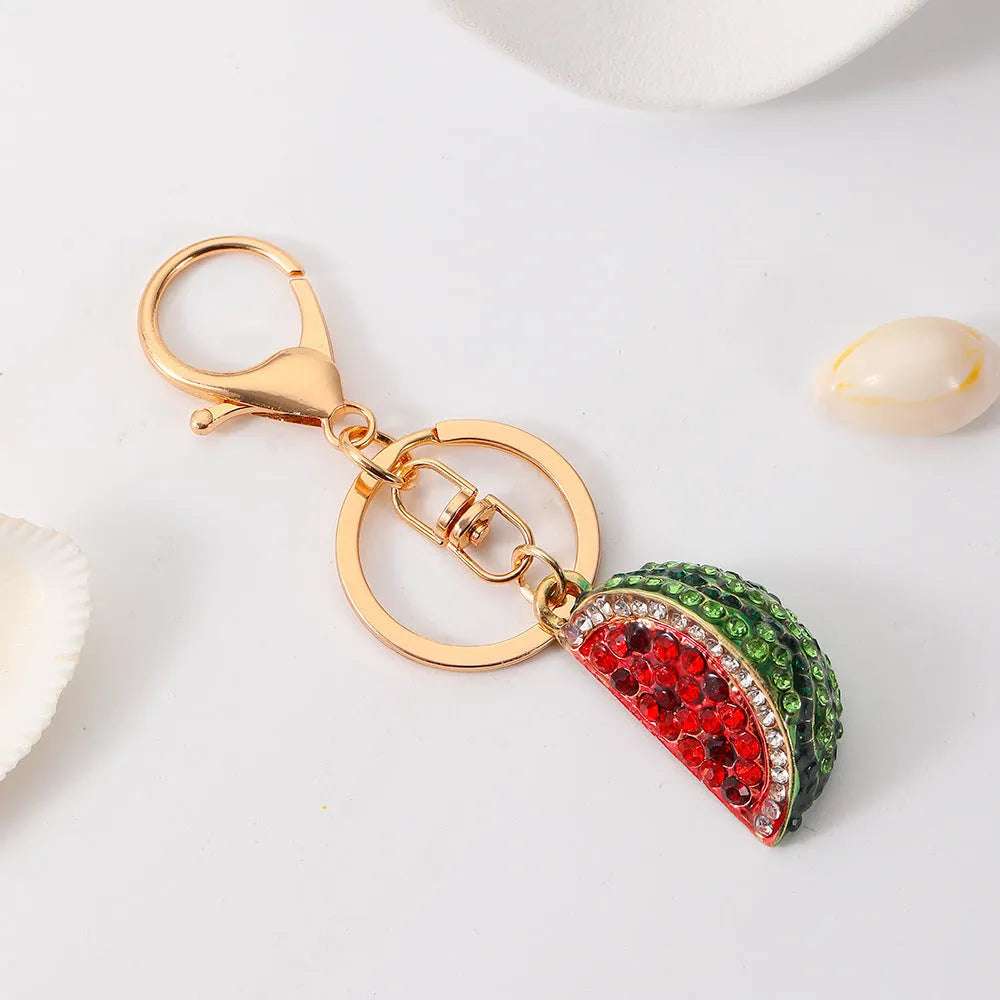 Creative watermelon shape metal car keychain in red on a white background