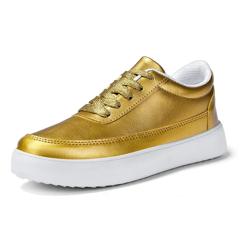 Women's leather flat casual trainers in gold, featuring front lace-up design on a white background.