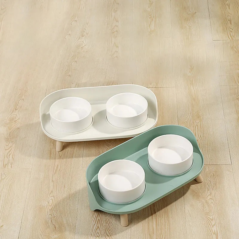 Tilted double bowl pet feeder in green with separate compartments for food and water