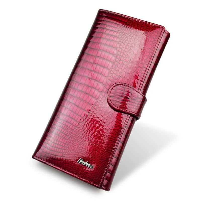 Red crocodile pattern patent leather women's coin purse with pigskin lining.