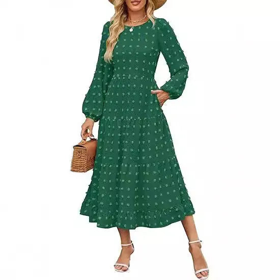 A woman wearing a beige high waist long sleeve dress with ruffle details on a autumn day.