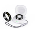 Black ceramic smart ring for health monitoring on a finger next to its charging case.