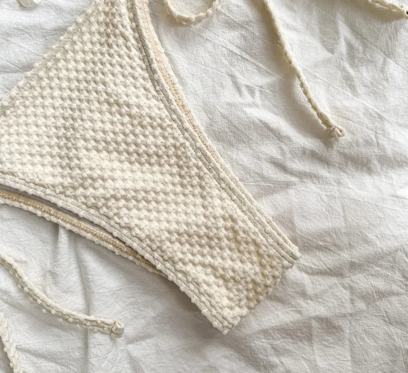Halter lace-up bikini in milky white, front view, polyester fiber fabric, women's swimsuit on beach